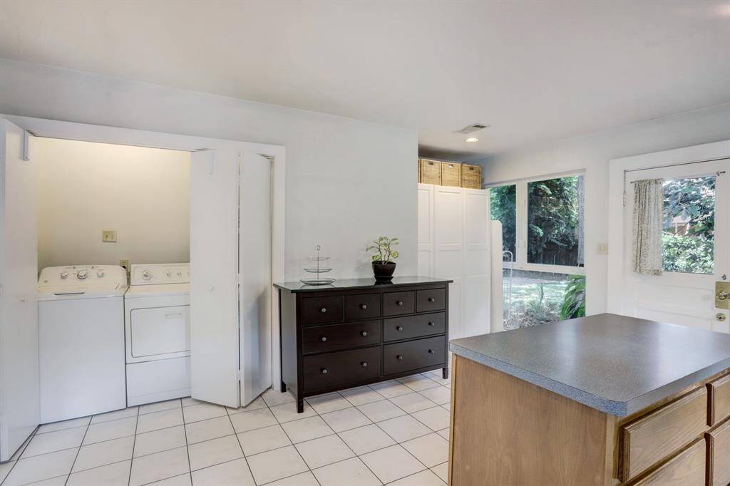 Full size laundry area with shelving and pantry.