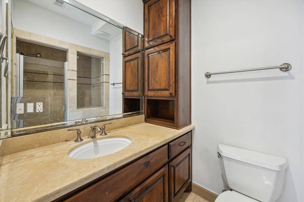 Full size bath found off third bedroom. Note seamless shower.
