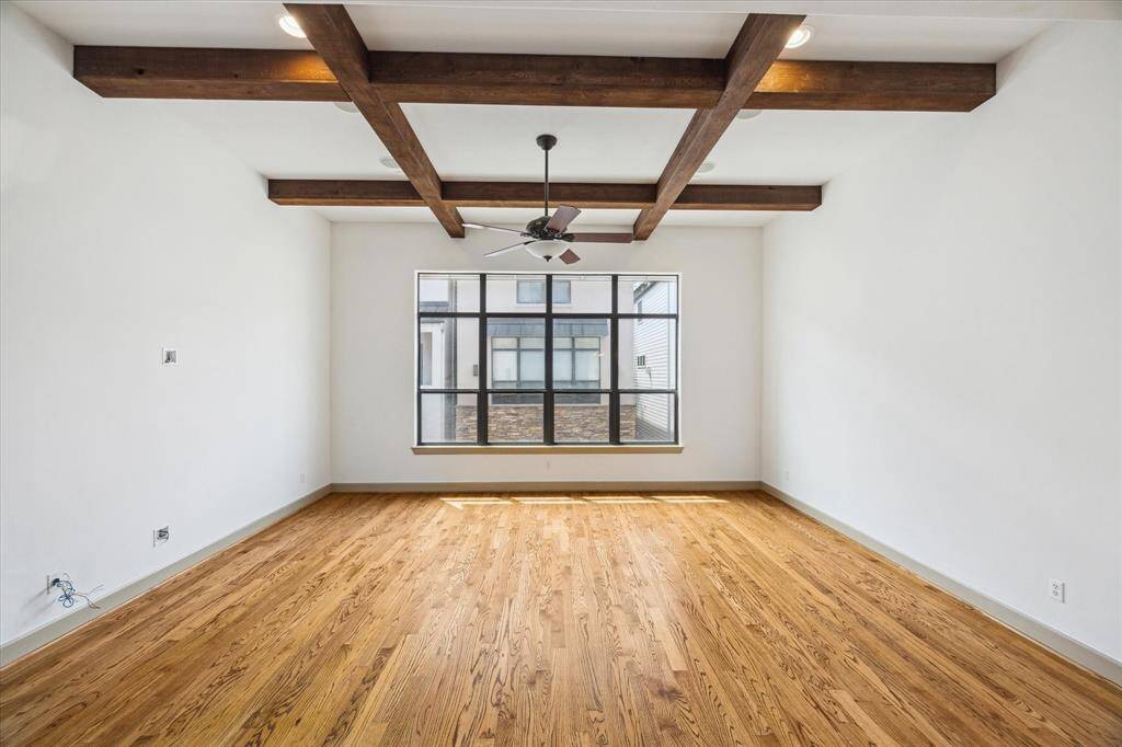 Note nearly floor to ceiling windows and gleaming hardwoods.