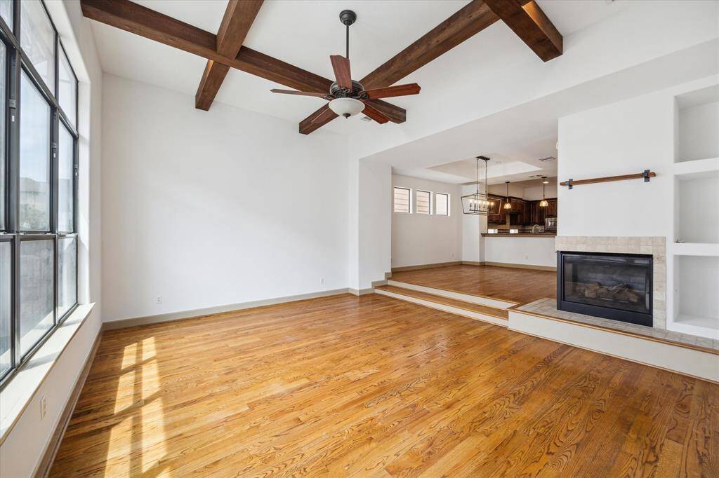 Note dual fireplace, built ins and ideal step down into living space allowing for open concept but defined space.