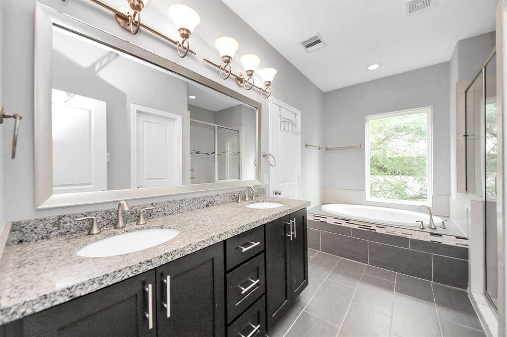 Primary bathroom has tons of natural light coming in!