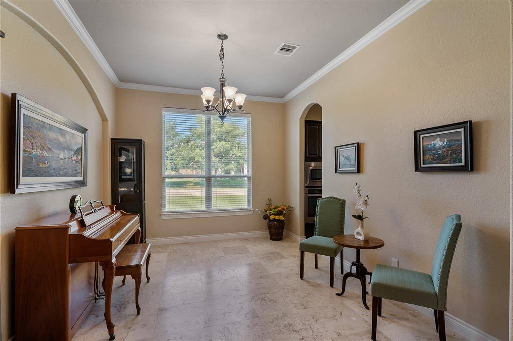 The well-proportioned dining room is used as a music room. This room has much natural lighting and architectural details.