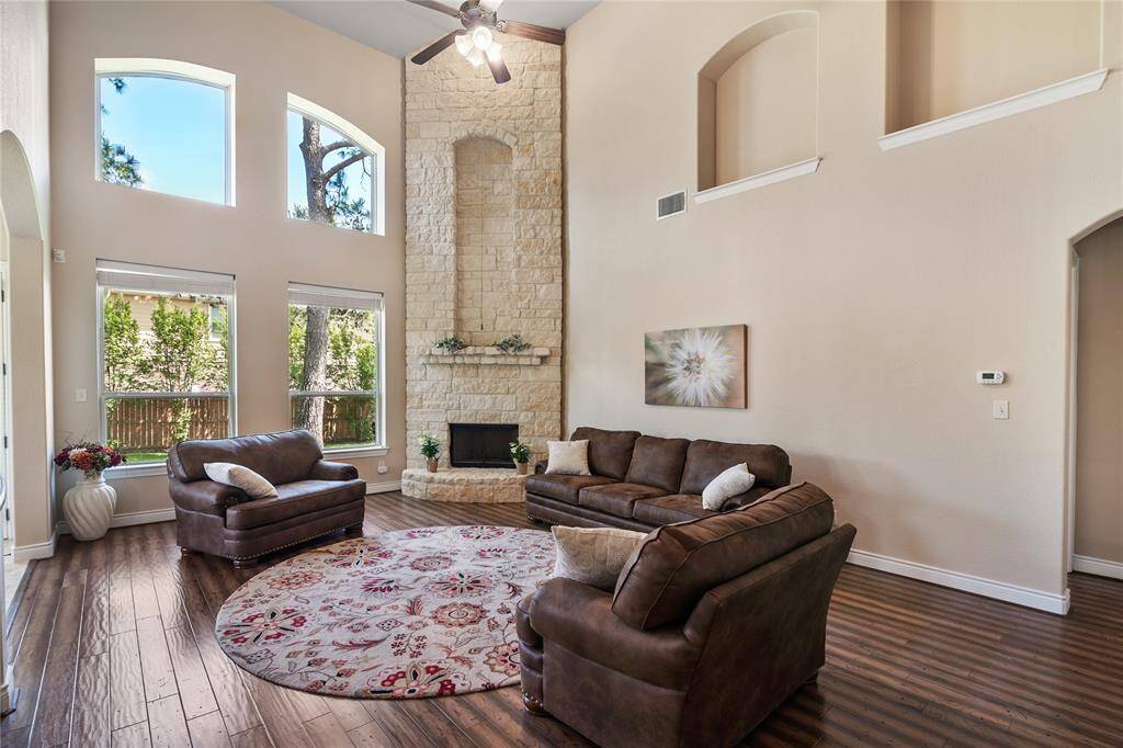 The distinguished oversized family room has countless architectural charms and a marvelous view of the enchanting backyard.