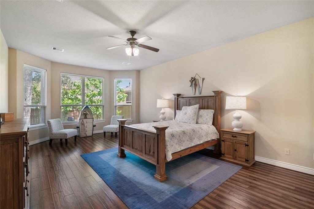 The well-proportioned primary bedroom features a ideally situated sitting area with fabulous engineered wood flooring and a bright view.
