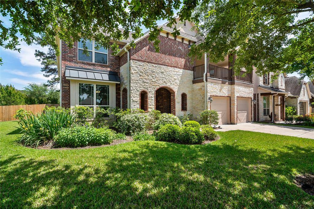 Enchanting front and side yard from this corner home with mature trees.