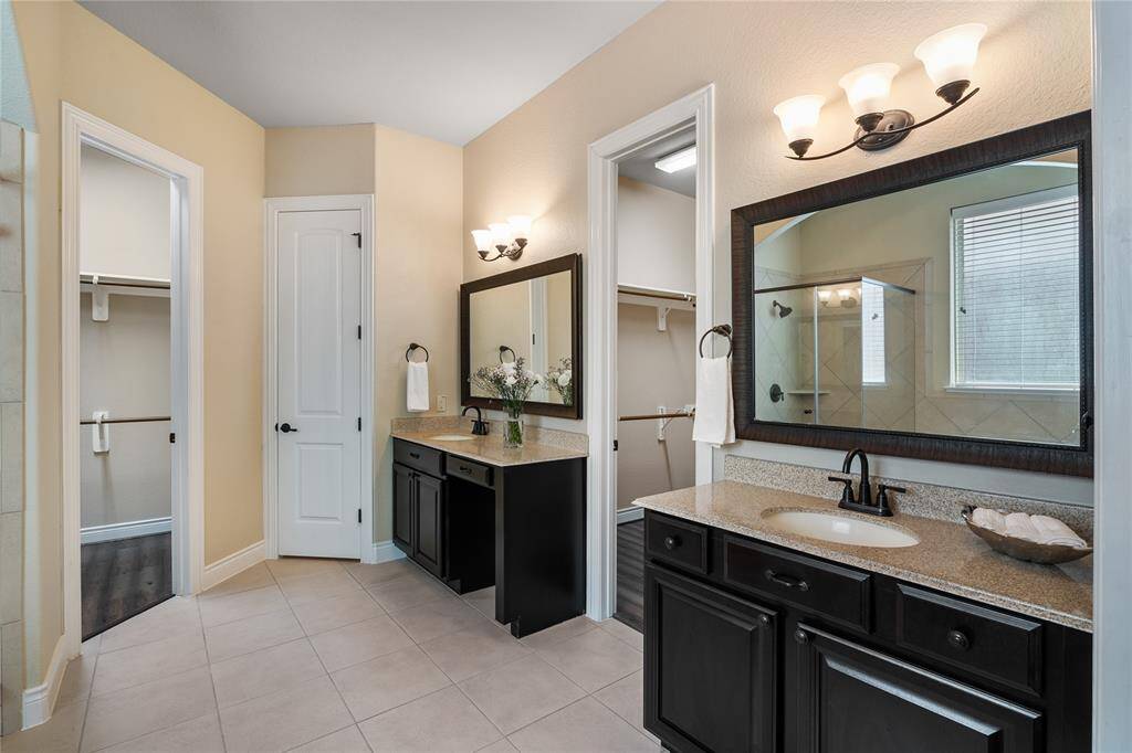 Elegantly appointed double sinks, as well as His and Her own closet.