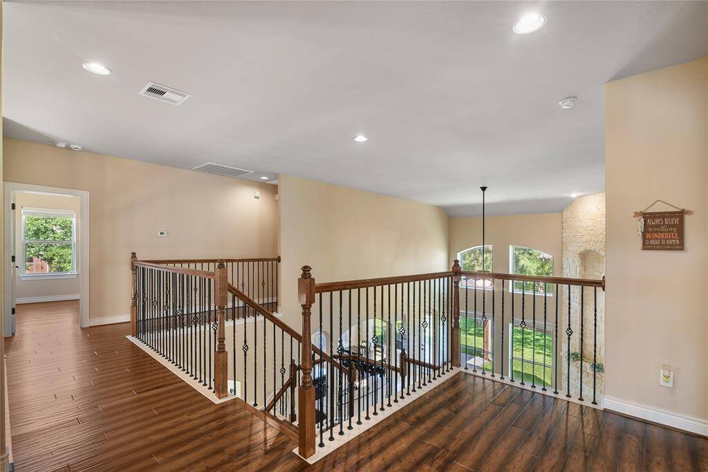 Coming upstairs you can admire the distinctive hand-railing with an open view of the home.