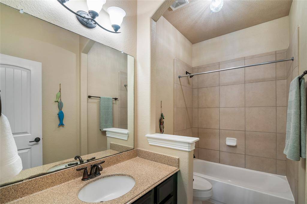One of the elegant secondary bathrooms upstairs, next to the media and game room.