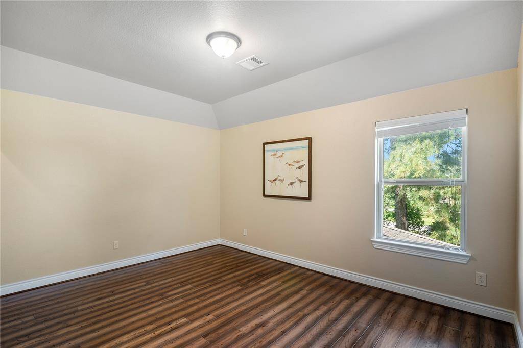 The third generous secondary bedroom with a view to the backyard.