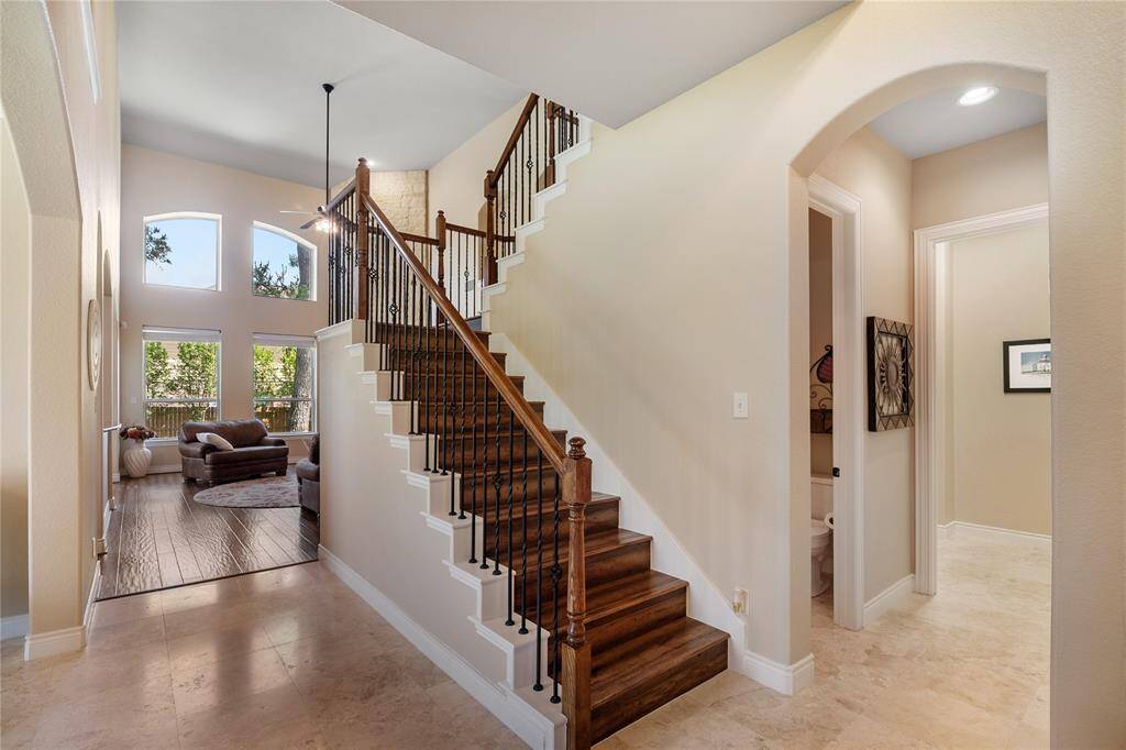 At the right side of the main entrance is the garage entrance, oversized laundry room, seamless half bathroom and the grandiose stairs.