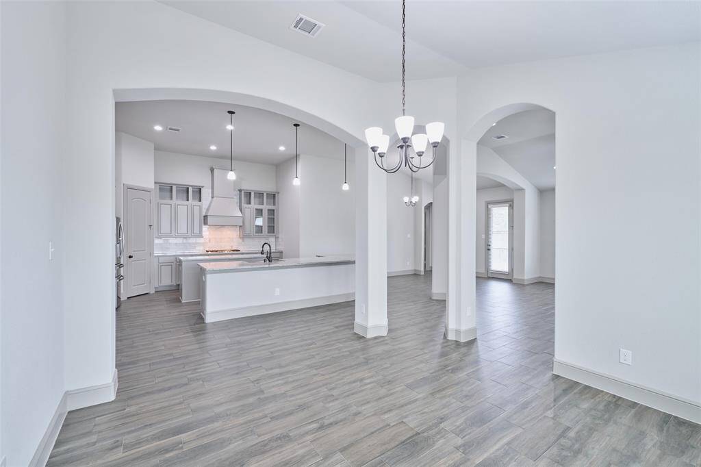 Formal dining area opening to Kitchen and family room to the right.