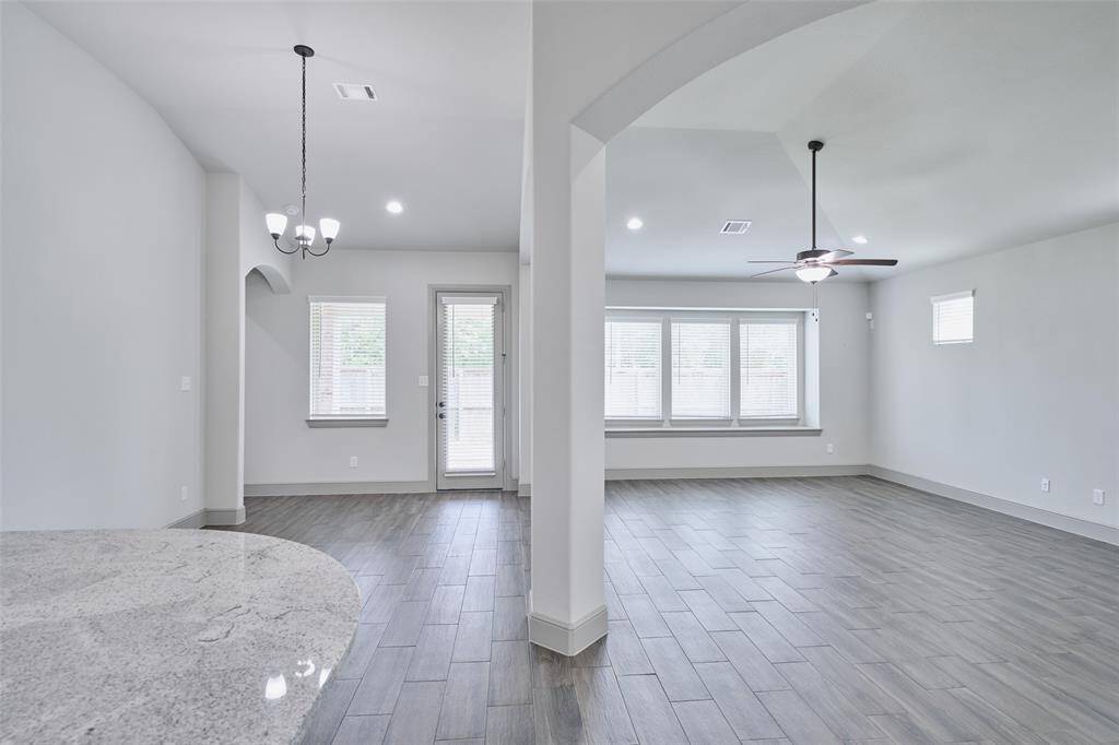 Dining area to close right with living area off kitchen.  High ceilings and beautiful tile floors for easy upkeep.