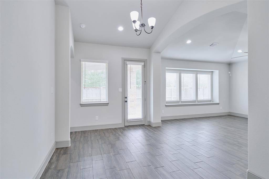 Breakfast area with door to covered patio and living room to right.