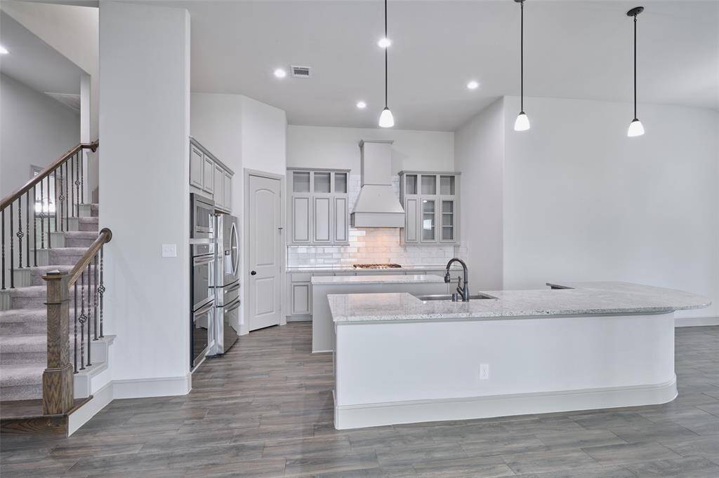 View of kitchen with stairs to game room and full bath.
