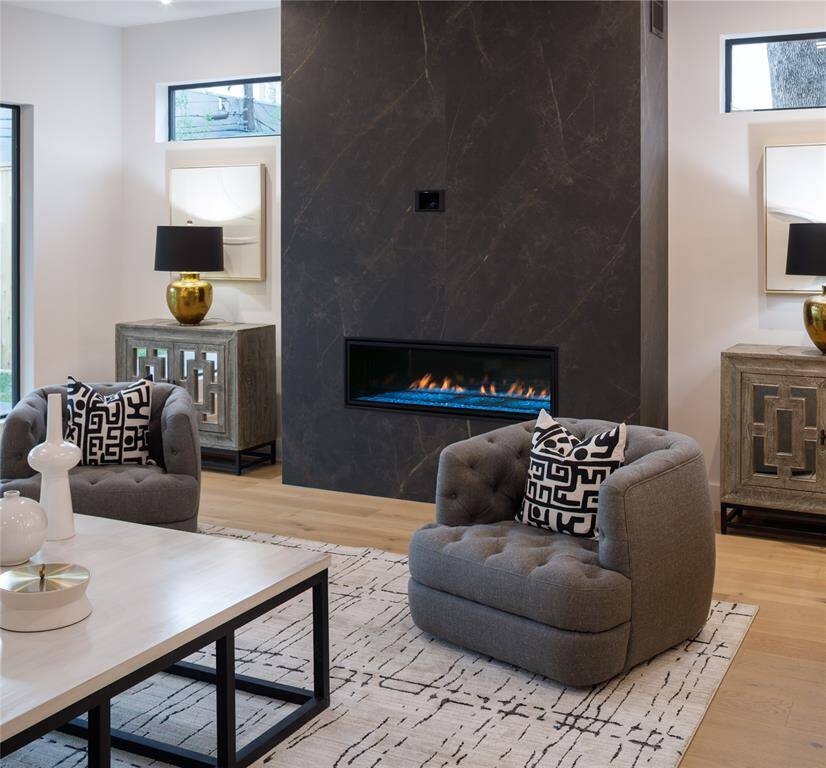 Stunning porcelain wall surrounding the fireplace and the symphony of exquisite finishes and sophisticated touches.