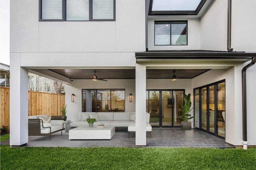 Turn your back yard into a year-round retreat.  Covered outdoor patio with ceiling fans, lights and spacious useful space for all sizes of entertaining. Photo is virtually staged