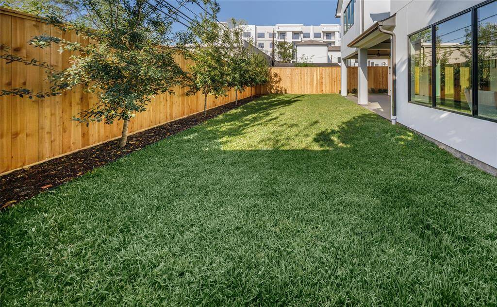 View of the large back yard. Tall fencing all the way around and plenty of room for a large pool.