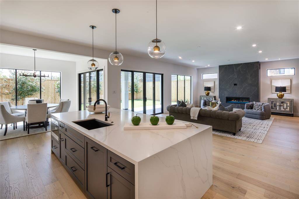 Open concept of the kitchen and living room adding a multi-functional space with flow that makes it easier to entertain and interact with guests