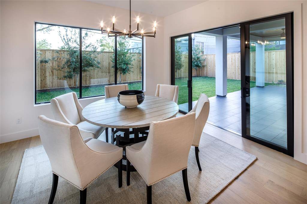 Generous size breakfast room with glass sliding door to the outdoor patio, back yard view and an elegant hanging chandelier