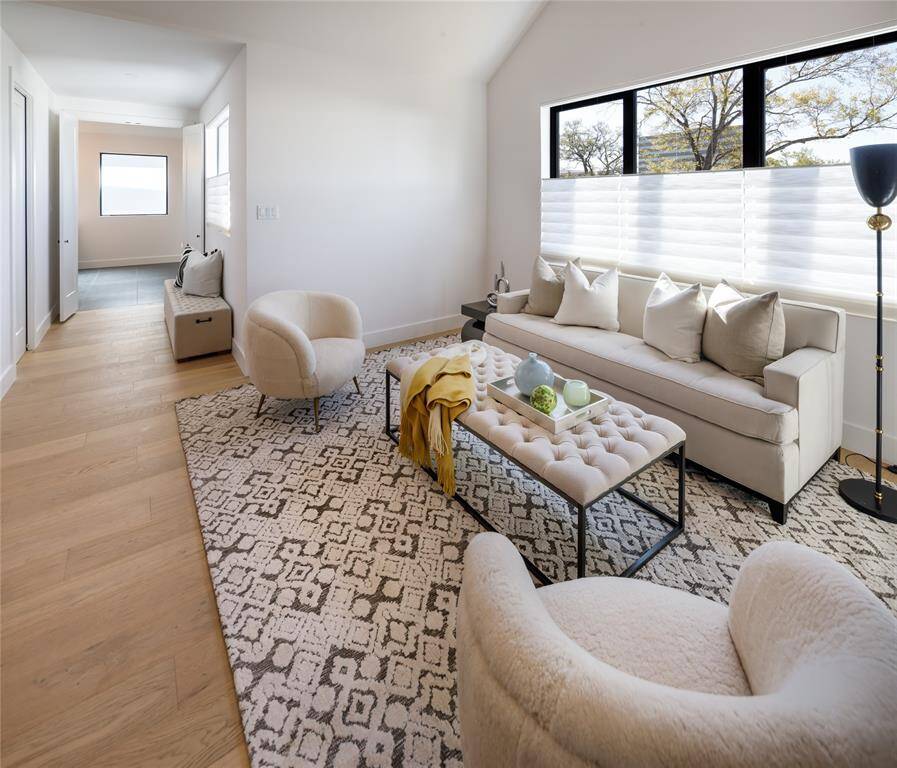 Alternate view of the primary living area through a hallway leading to the primary bathroom