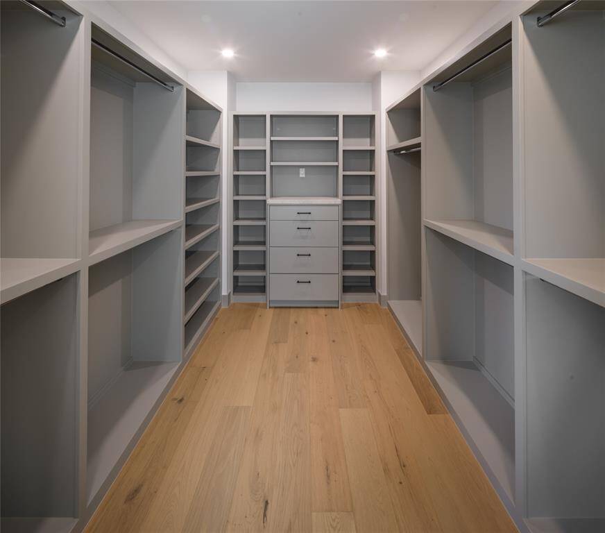His private dressing area with custom-built cabinetry and shelves