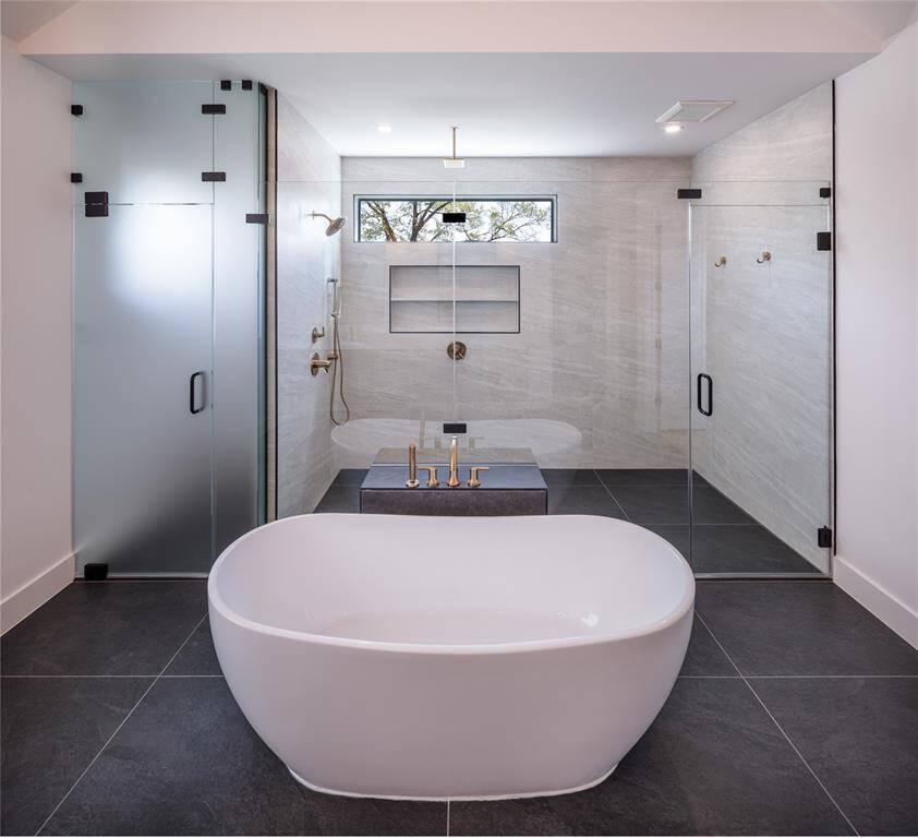 Alternate view of the primary bathroom with frosted glass door to the water closet for privacy