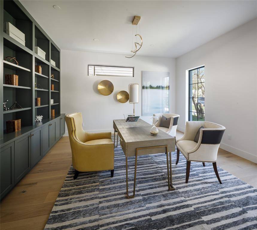 A beautifully designed and functional home office with custom-built book shelves and cabinetry