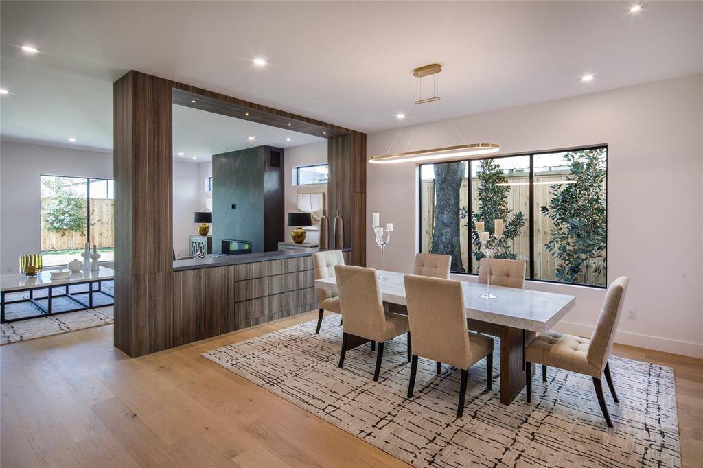 Foyer entry transitions into the formal dining room with unique furniture style built-in buffet, large windows creating valuable natural light.