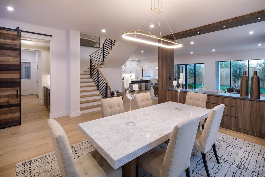 Charming and space saving sliding barn door separating the dining room from the bar and adding functional style to your space