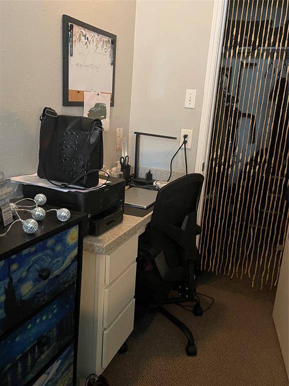 This built-in desk is located in the bedroom. The area to the right is the walk-in closet.