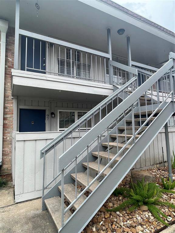 The exterior staircase leading to an upper-level unit #98.