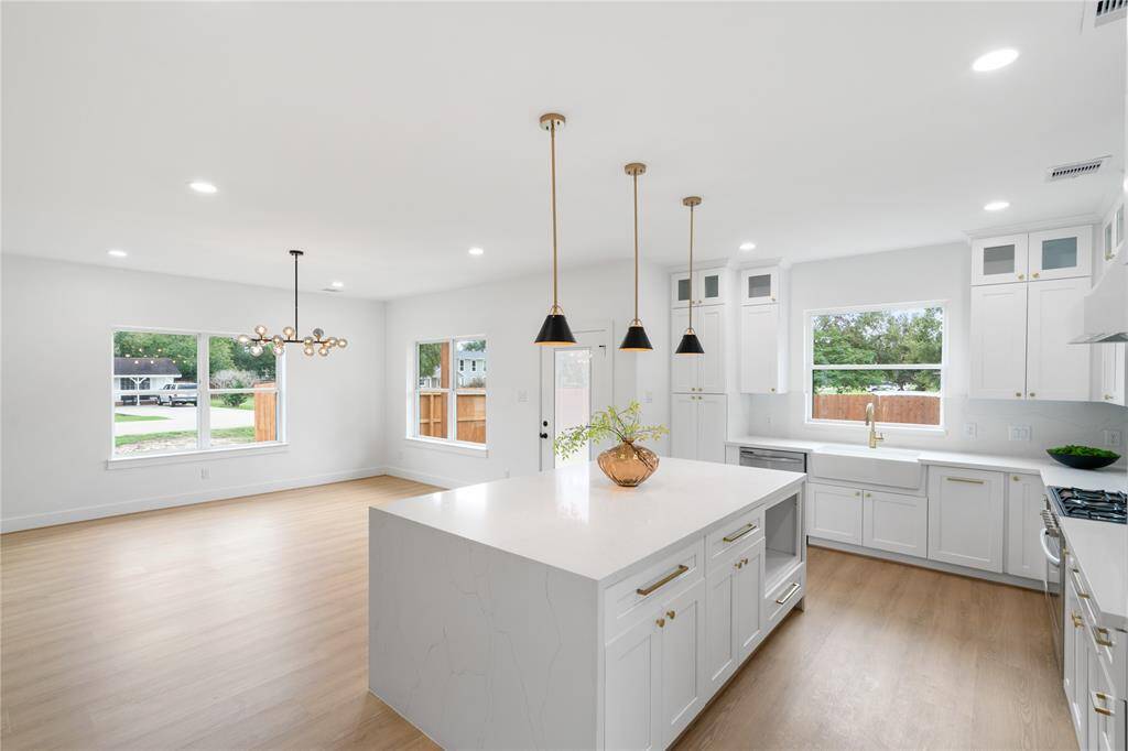 The dreamy kitchen opens up to dining room, easy access to the back yard entertainment!