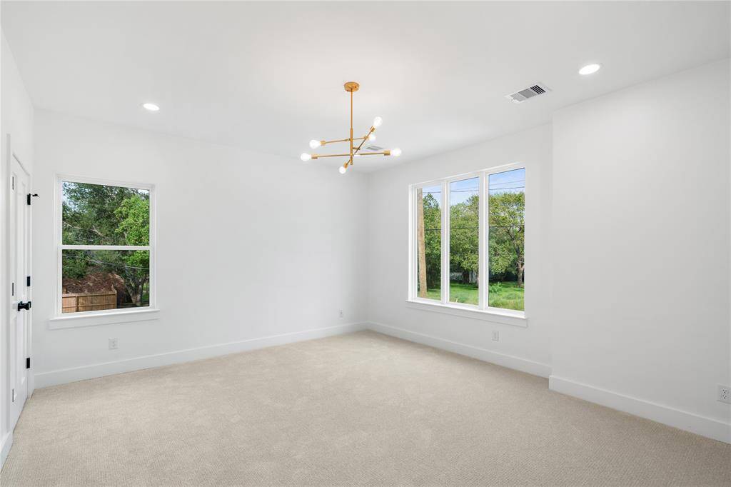 This bedroom offers spa-like bathroom and walk-in custom closet