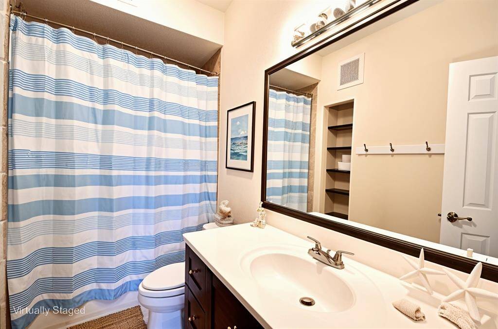The second bedroom offers a lovely window view and versatile space—ideal for a home office, nursery, personal gym, or whatever your heart desires.