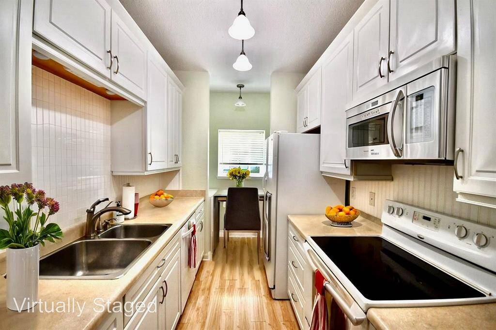kitchen is conveniently located near the washer and dryer, making it easy to multitask—perfect for busy moms (or anyone!) looking to get things done efficiently.