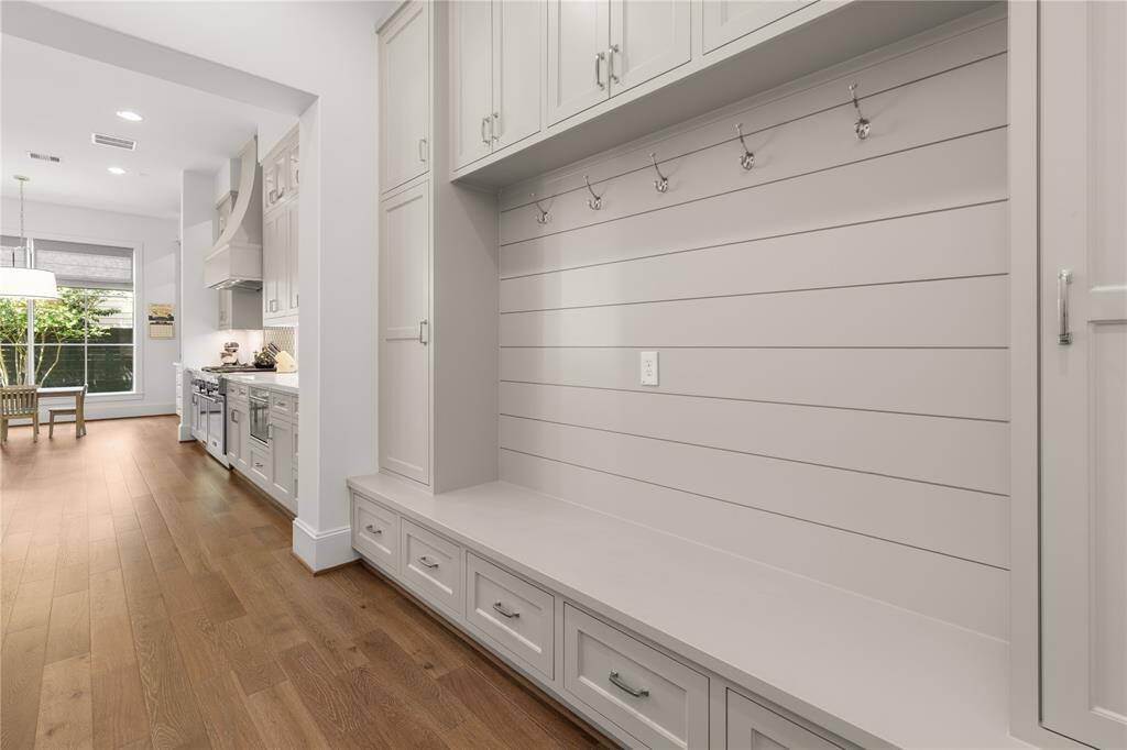 Mud-Room just off the garage w/ drawers, hooks, upper cabinets and side lockers.