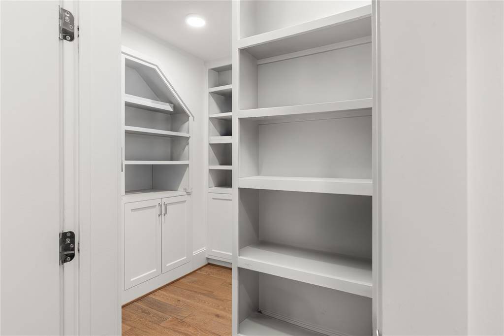 A dream of a pantry - full of shelves & cabinets.