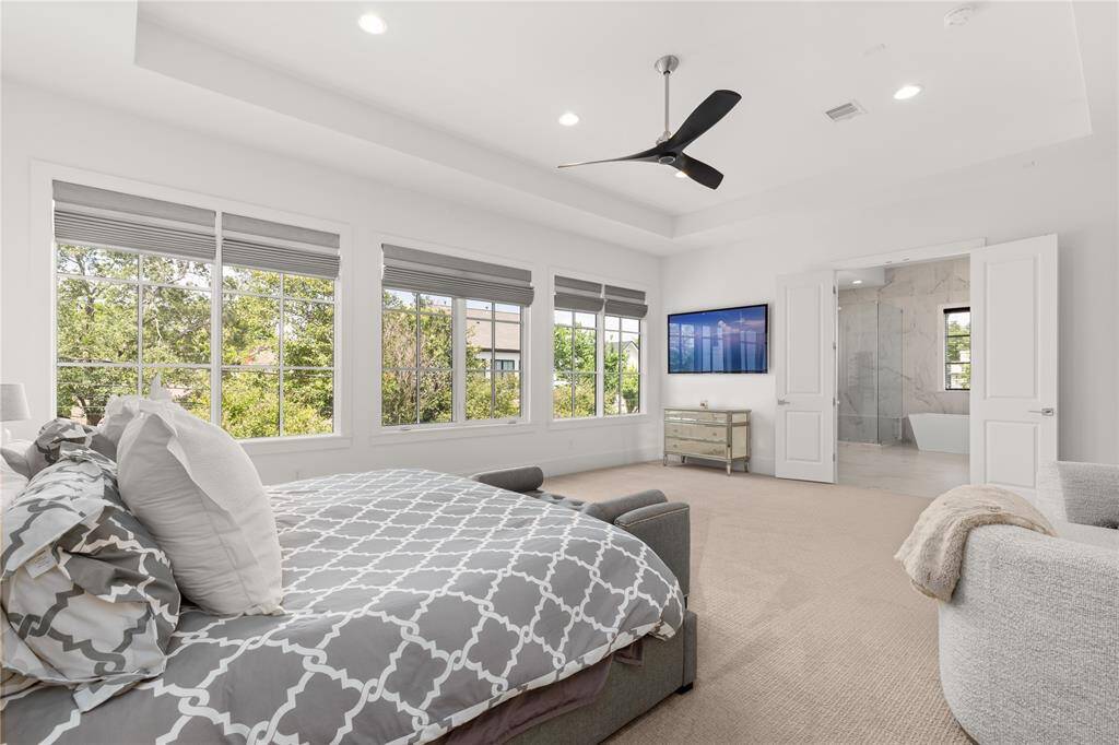 Tray ceiling w/ recessed lighting, Minka Aire 6-speed ceiling fans, & custom shades.