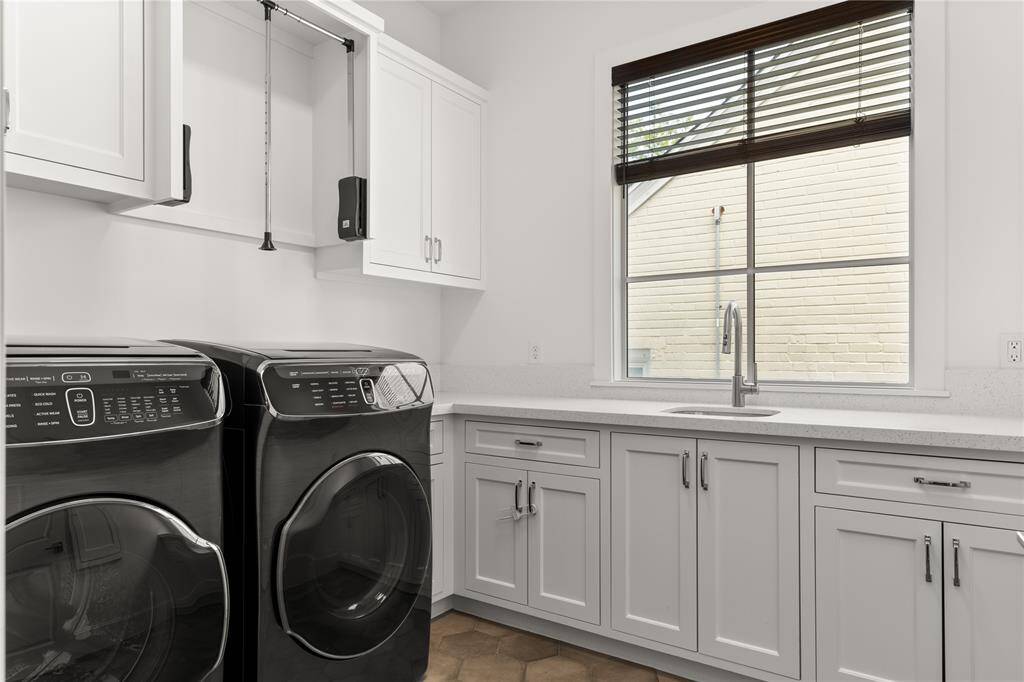 Convenient laundry room up w/ deep utility sink & plenty of storage space. Gas & electric connections; custom cabinets to accommodate large machines.