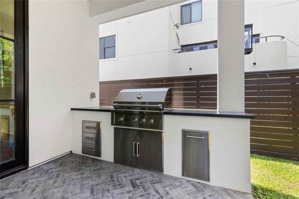 Stainless steel drawers, trash receptacle, gas grill, granite countertops for prep.