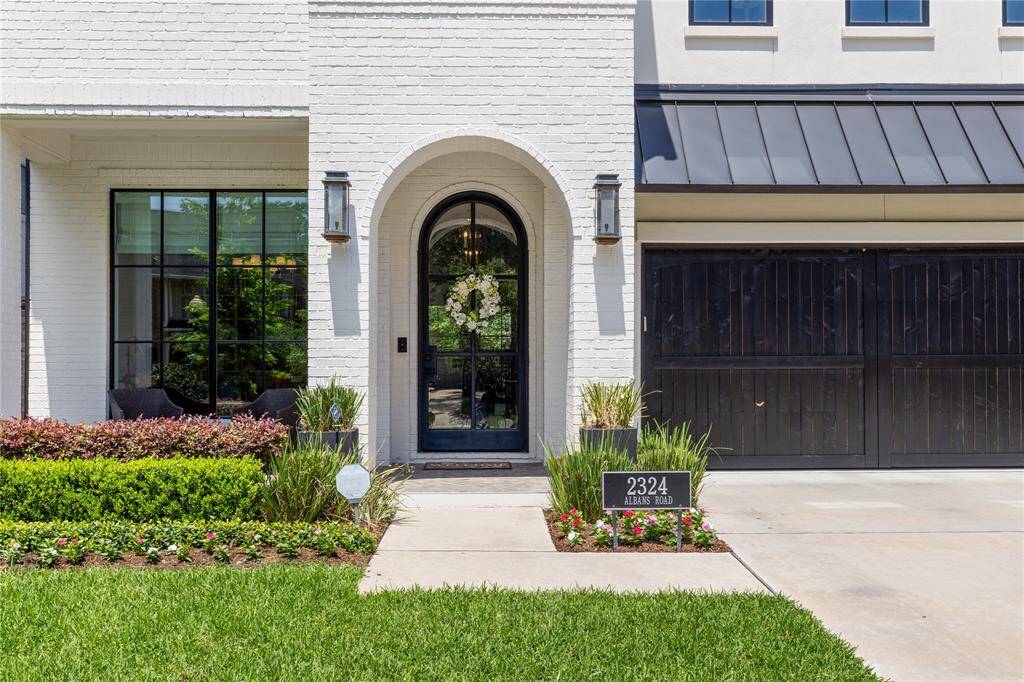 Gas Lanterns & Ebony Stained wood panel garage door.