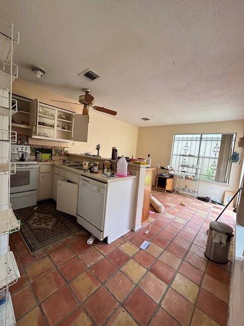 The charming kitchen is a great gathering place with a cute breakfast are counterspace/cabinets galore.