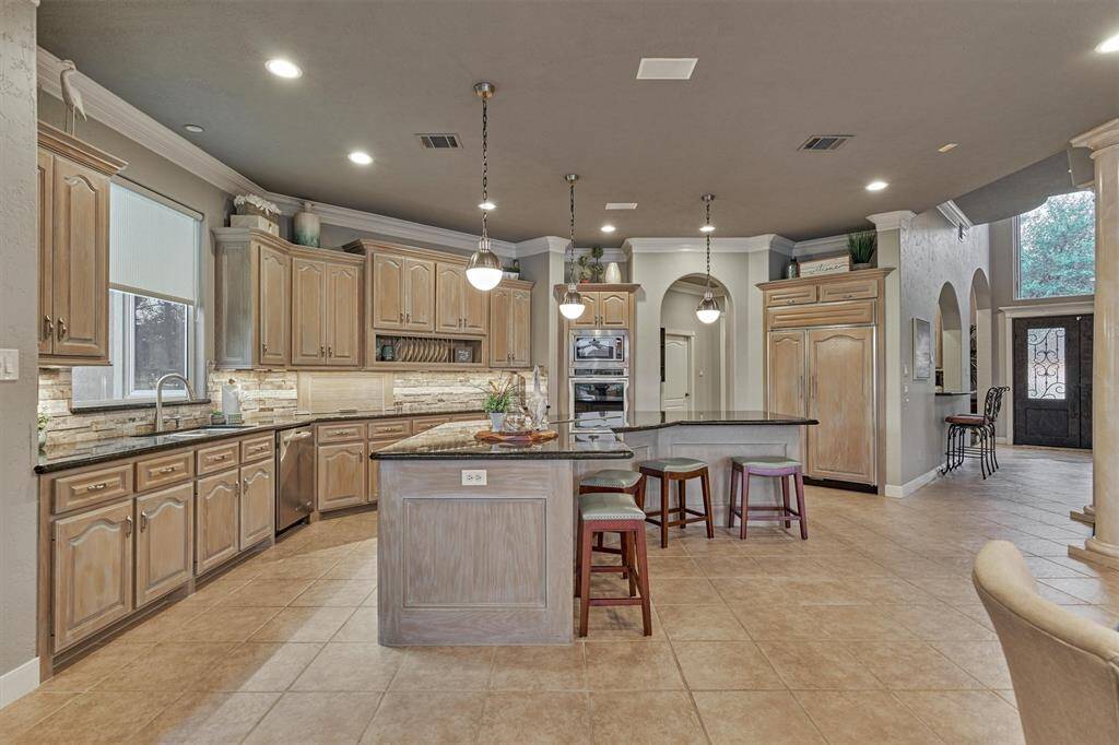 The lower cabinets feature built-in pull-out drawers, offering practical and ergonomic benefits that enhance both functionality and organization in the kitchen.