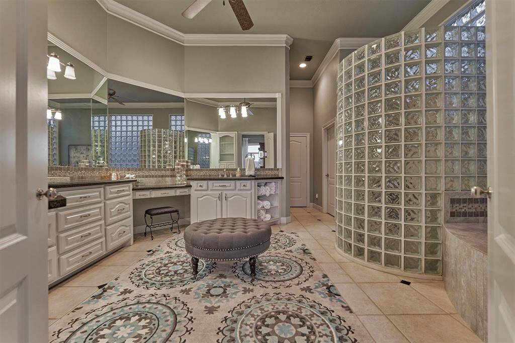 The luxurious primary bath offers double sinks, a dedicated vanity area, a relaxing soaking tub, and a separate walk-in shower—perfectly designed for comfort and convenience in a refined setting.