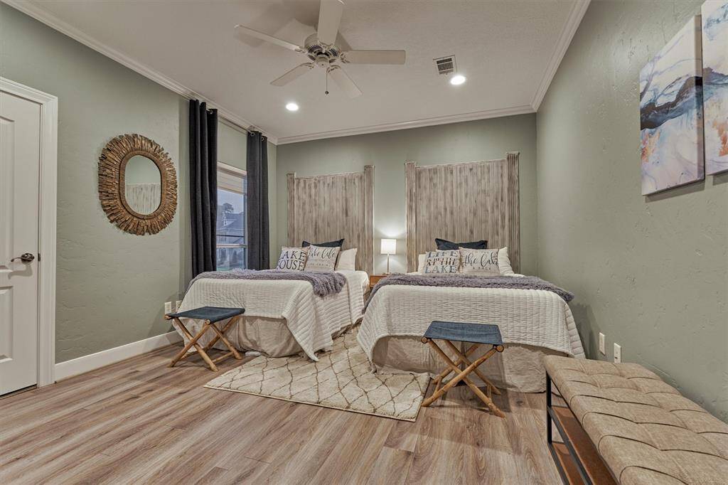 The first guest bedroom features its own en-suite bath and walk-in closet, offering comfort and privacy. Serene finishes create a lake-like vibe throughout all of the guest suites.