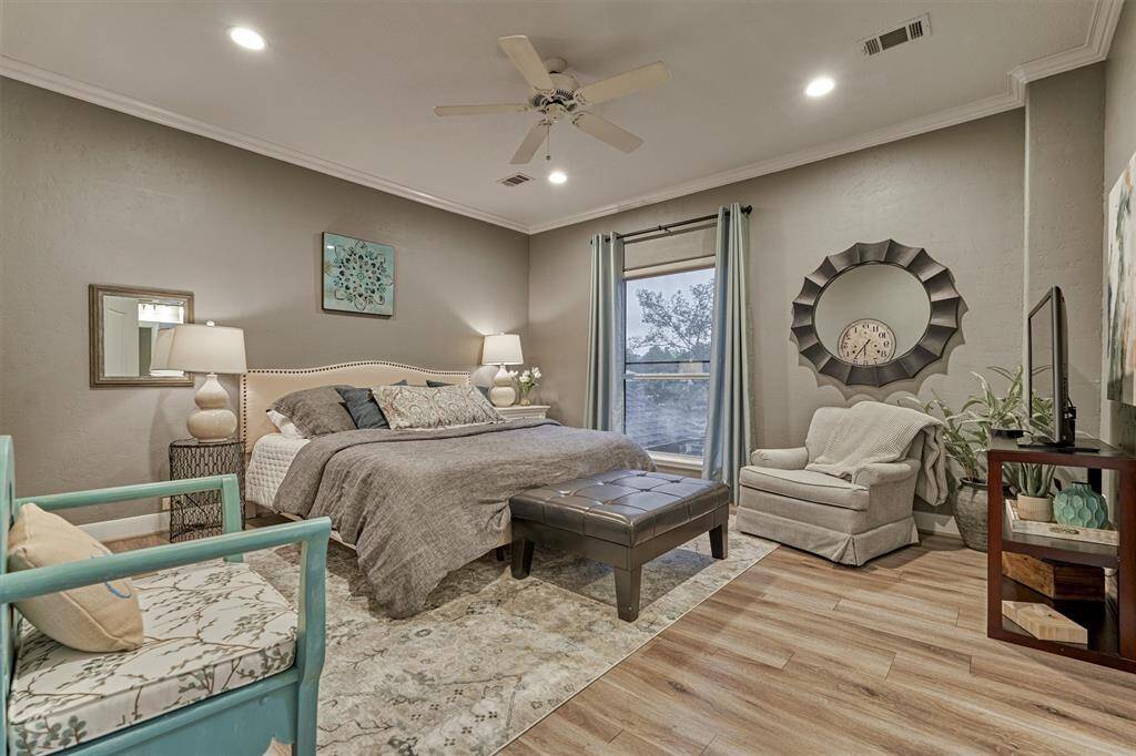 A second guest bedroom features similar finishes, complete with its own en-suite bath and walk-in closet, providing a peaceful and private retreat for guests.