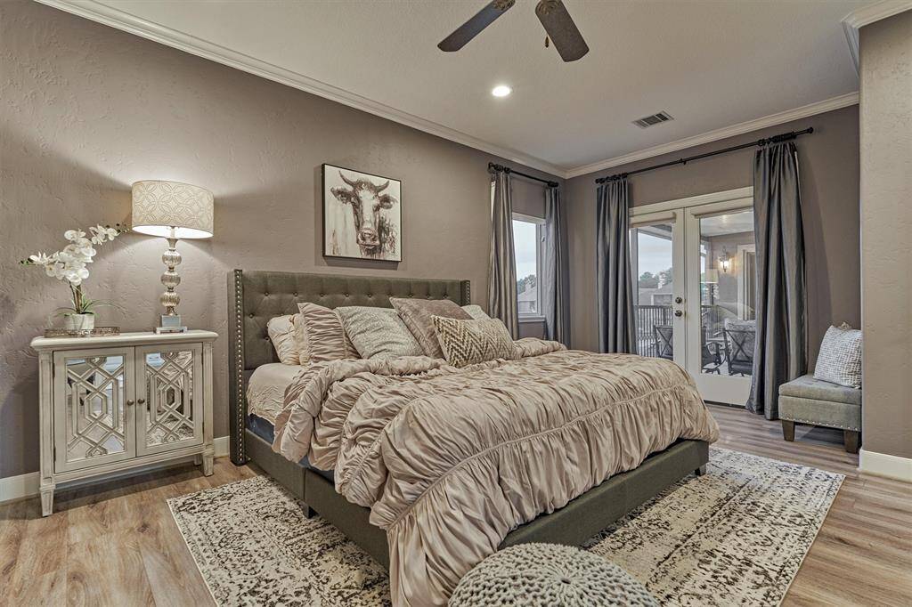 The third upstairs guest bedroom features double doors that open to the screened-in balcony with direct access to a full bath. Every guest room in this home is designed with comfort and relaxation in mind, ensuring a welcoming stay for all.