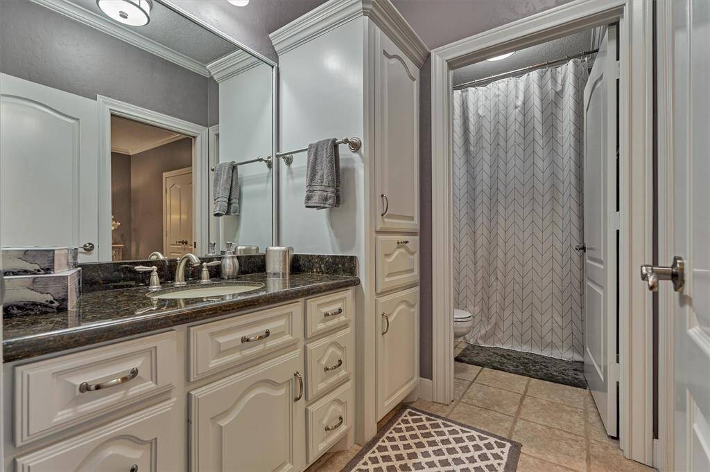A full bath with a private toilet and tub area serves the third guest bedroom and also offers convenient access from the game room, perfect for guests and everyday use.