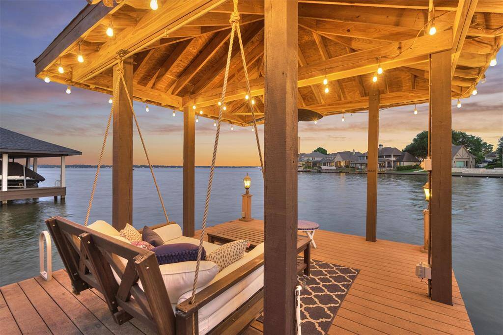 Spend your evenings unwinding in the cozy covered gazebo overlooking the lake- a perfect spot to relax and take in the tranquil surroundings. (Swing not included with the home.)