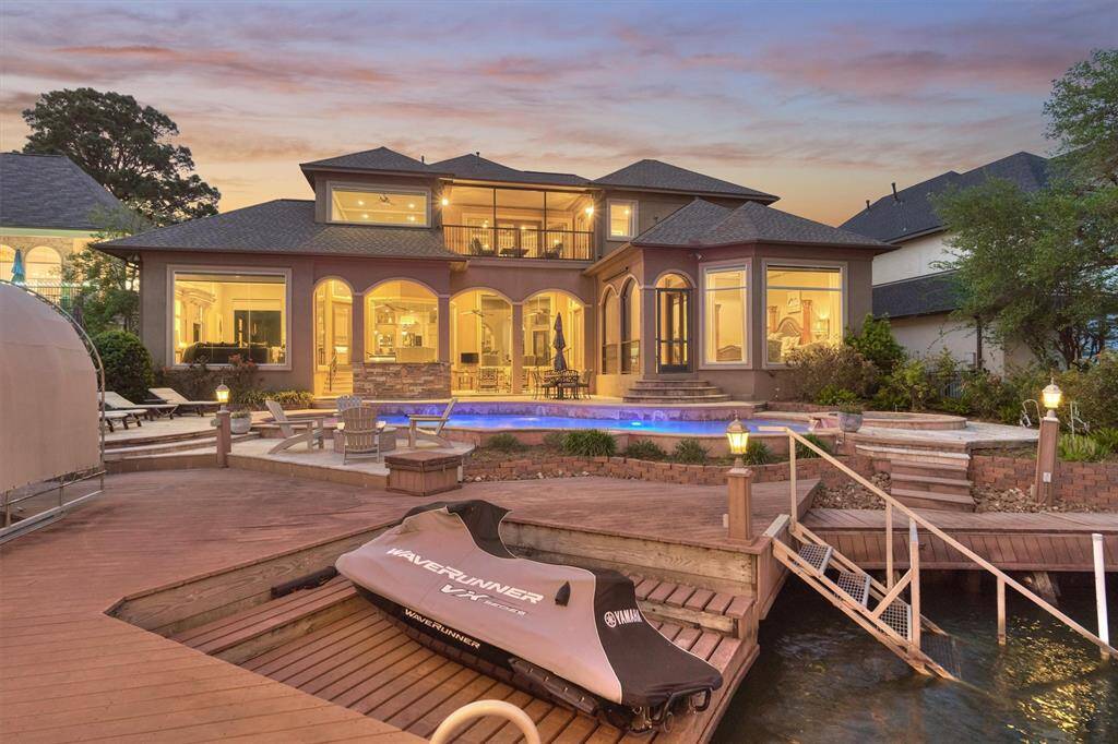 The home shines beautifully from the lake at night. The jet ski platform is designed to raise and lower with ease, providing convenient and efficient access to the lake whenever you're ready to ride.